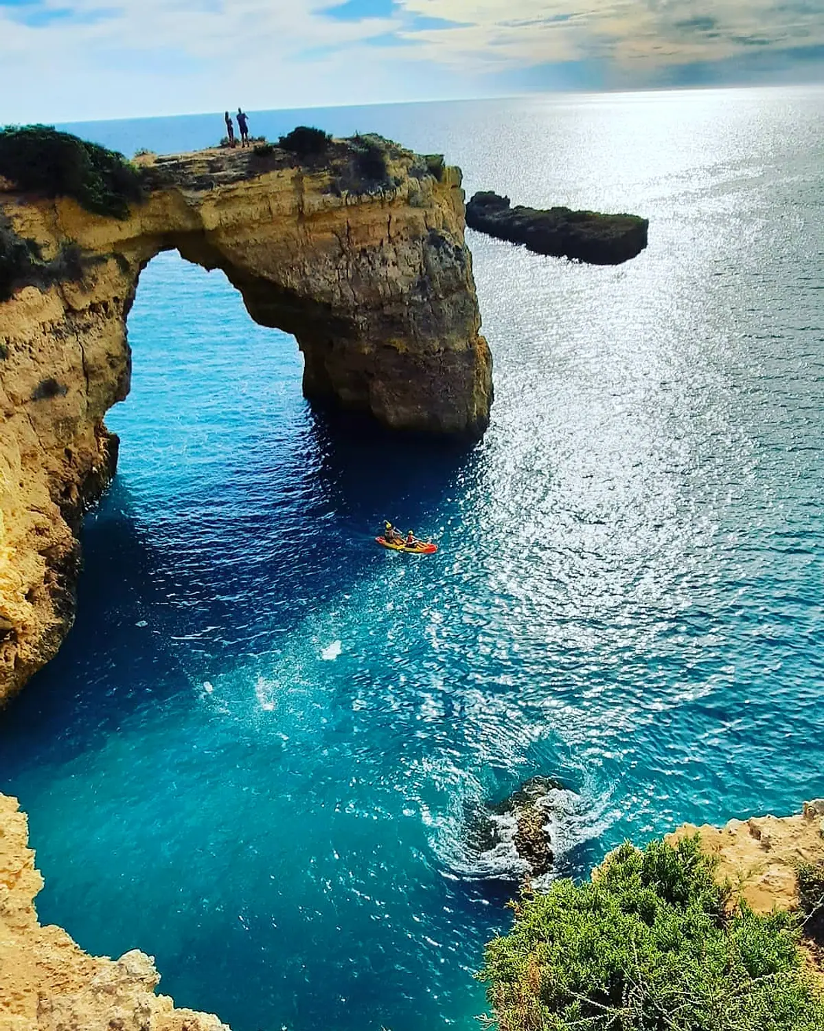 Turquoise water beneath a coastal rock arch