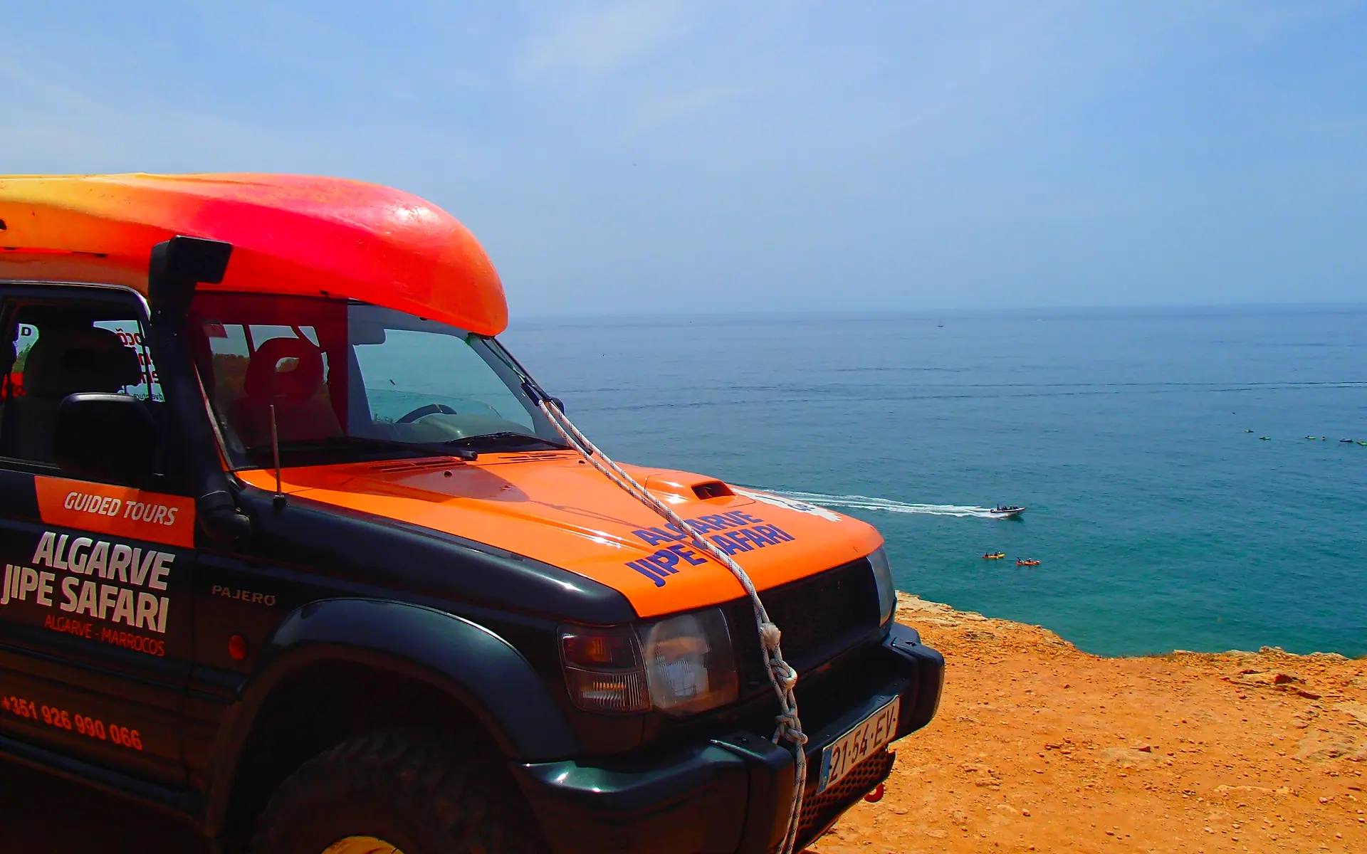 Orange Algarve Jipe Safari jeep on a cliff above the Atlantic
