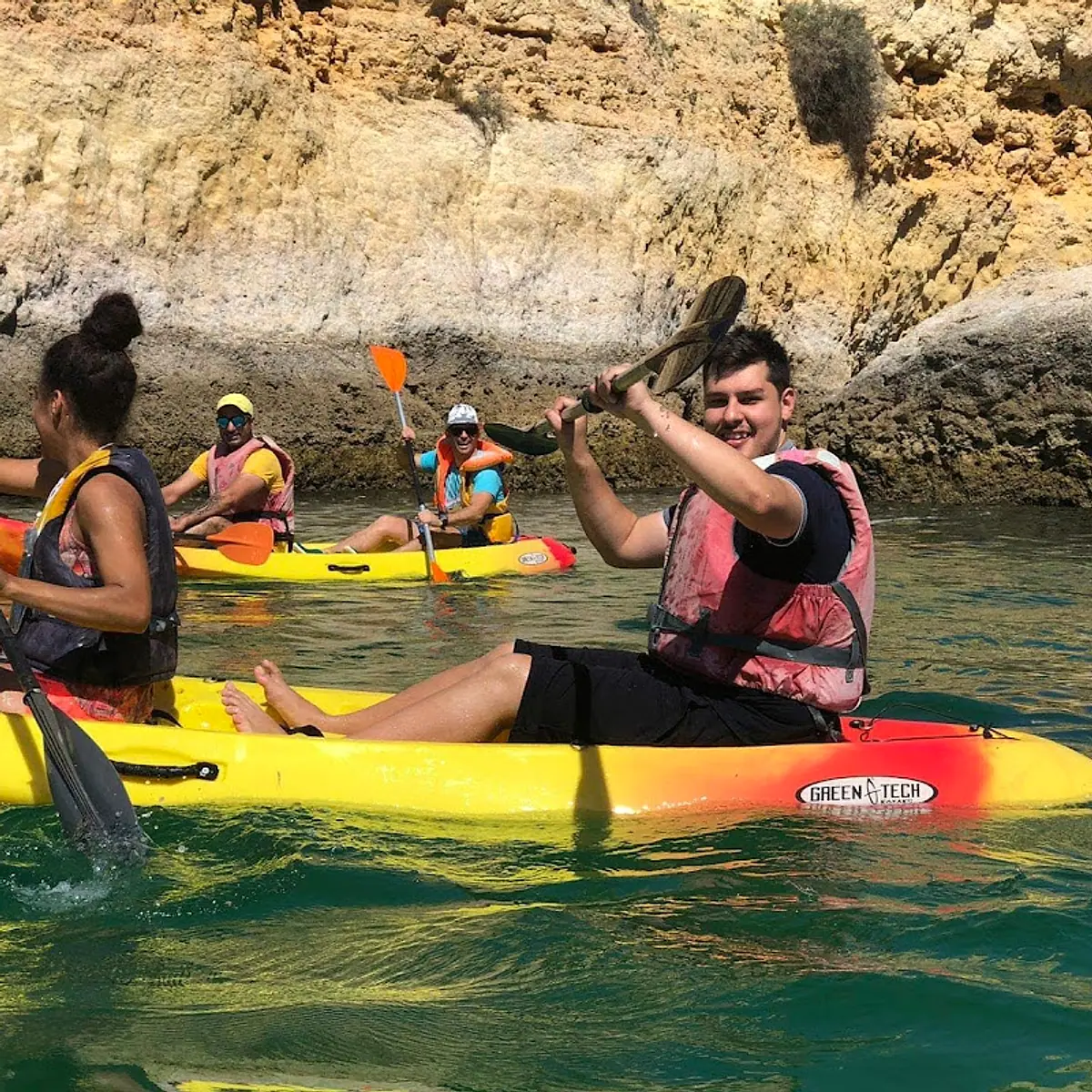 Kayakers preparing beside a limestone cove