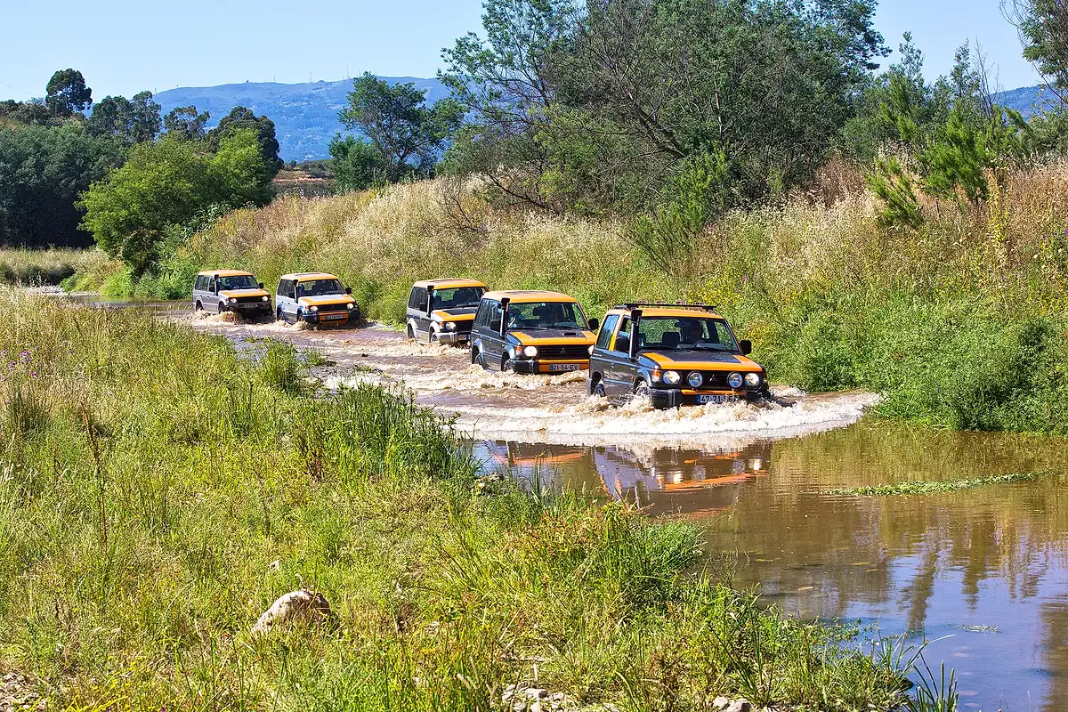 Jeeps crossing a river track towards Silves